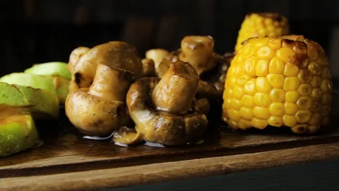 Closeup shot of grilled corn mushrooms and zucchini, rotates on the turntable. Stock Footage