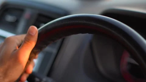 Closeup shot of hand of an Indian man turning the steering wheel of the car Stock Footage 156421377