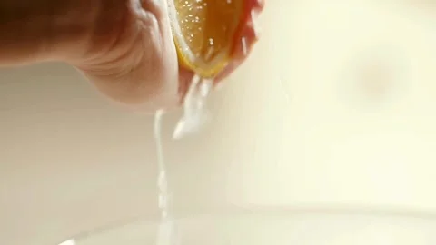 Closeup shot of hand squeezing lemon. Lemon juice coming out of lemon. Stock Footage 265838792