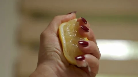 Closeup shot of hand squeezing lemon. Lemon juice coming out of lemon. Stock Footage 265839827