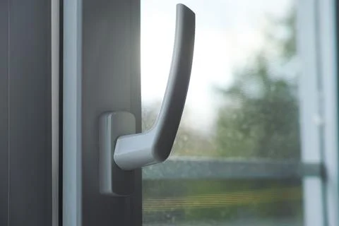 A closeup shot of the handle of a window Stock Photos