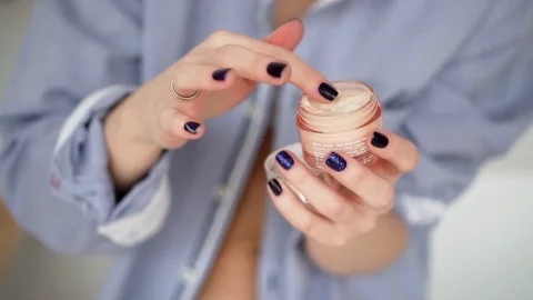 Closeup shot of hands applying moisturizer Stock Footage 104973191