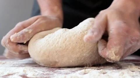 Closeup shot of hands chef bakery man kneading dough applying flour on doug.. Stock Footage 272469477