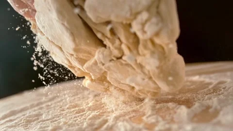 Closeup shot of hands chef bakery man kneading dough applying flour on doug.. Stock Footage 272469564