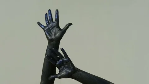Closeup shot of hands covered with black paint bright blue sequins Stock Footage 76473961
