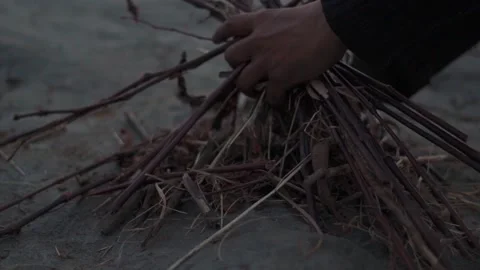 Closeup shot of hands of an Indian man igniting campfire after the sunset  Stock Footage 228190878