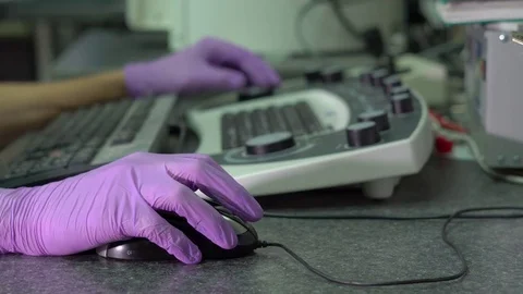 Closeup shot of hands of a scientist working on an scanning electron microscope Stock Footage 77326848