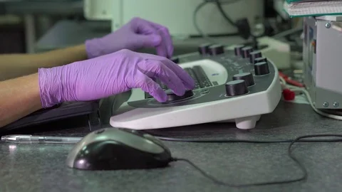 Closeup shot of hands of a scientist working on an scanning electron microscope Stock Footage 77329321