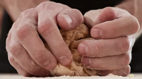Closeup shot of hands of senior chef kneading dough. Making pasta using Stock Footage 150780464