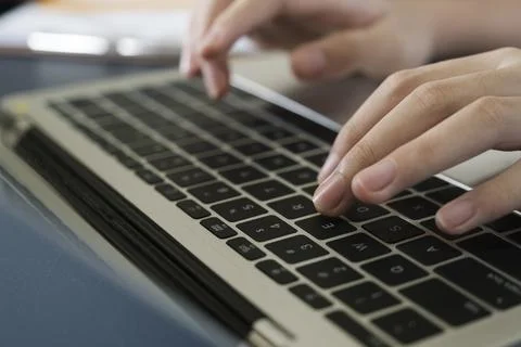 Closeup shot hands using laptop computer Stock Photos