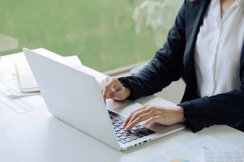 Closeup shot of hands using laptop and typing on keyboard, searching information Stock Photos