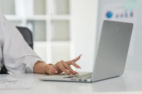 Closeup shot of hands using laptop and typing on keyboard, searching information Stock Photos