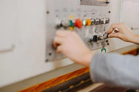 Closeup shot of hands working the buttons of an industrial machine Stock Photos