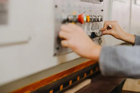 Closeup shot of hands working the buttons of an industrial machine Stock Photos