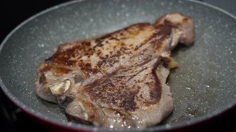 Closeup shot of a healthy T-bone steak cooking in the pan. beef meat Stock Footage 215919879
