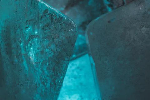 Closeup shot of ice cubes under turquoise light Stock Photos