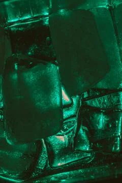 Closeup shot of ice cubes under green light Stock Photos