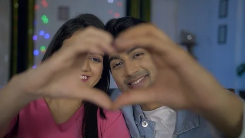 Closeup shot of Indian lovers making a heart shape with hands - valentine's day Video stock 123084527