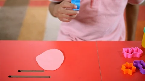 Closeup shot of a kid making shapes with clay Stock Footage 114055259