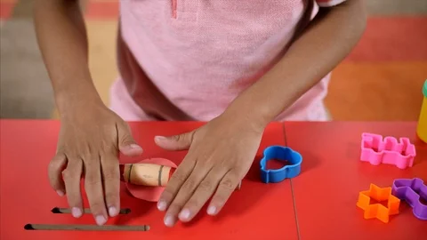 Closeup shot of a kid rolling a clay dough Stock Footage 114055213