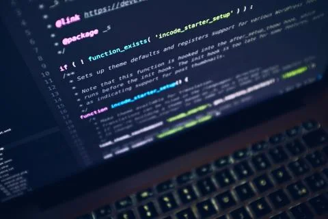 Closeup shot of a laptop's screen with lines of code on a black background Stock Photos