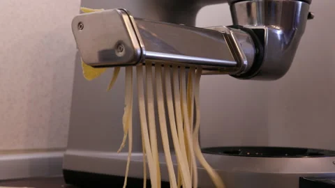 Closeup shot of making fresh pasta (spaghetti) on a pasta machine Stock Footage 169507719