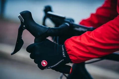 Closeup shot of male hands holding bike handlebars wearing Castelli Perfetto Stock Photos