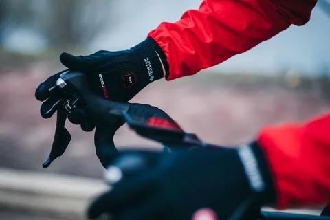 Closeup shot of male hands holding bike handlebars wearing Castelli Perfetto Stock Photos