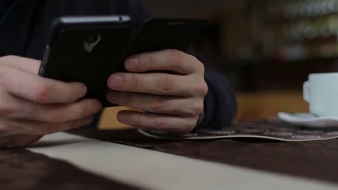 Closeup shot of male hands using smartphone in cafeteria Stock-Footage 73616794