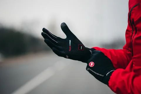 Closeup shot of male hands wearing Castelli Perfetto cycling black winter gloves Stock Photos