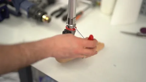 Closeup shot of a man assembling prosthetic foot with screwdriver Stock Footage 236621826