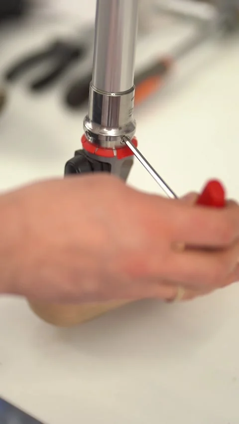 Closeup shot of a man assembling prosthetic foot with screwdriver. Vertical Stock Footage 237606326