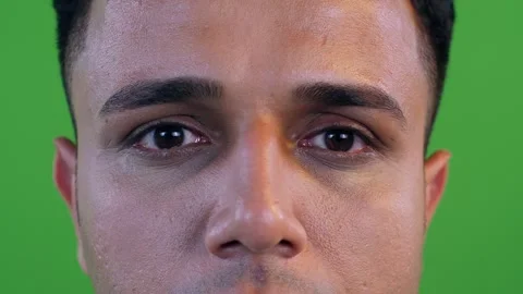 Closeup shot of a man looking at the camera with an angry expression - green ... Stock Footage 251617315