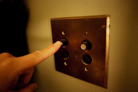 Closeup shot of a man pushing a button of an elevator Foto stock