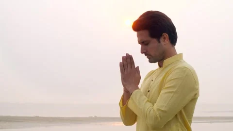Closeup shot of a man standing with a closed eye praying Lord Sun - celebrati... Stock-Footage 254775716