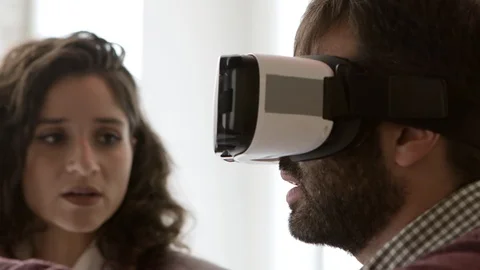 Closeup shot of man wearing virtual reality headset and gesturing Video stock 121001122