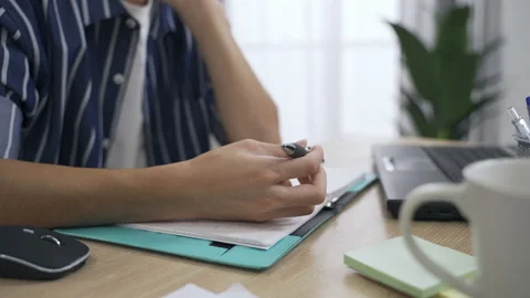 Closeup shot mans hand resting on office desk 動画素材 163693138