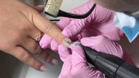 Closeup shot master uses electric machine remove nail polish during manicure Stock Footage 80594701