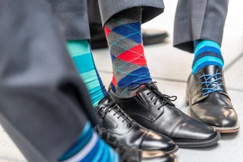 A closeup shot of men wearing patterned colorful socks with suits and classy  Stock Photos