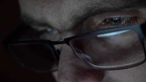 Closeup shot of middle age man in glasses surfing internet at night Video stock 71997224