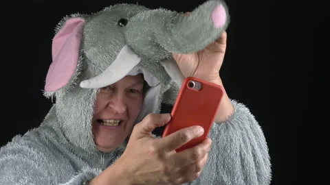 Closeup shot of a middle-aged lady in an elephant costume on a video call. Stock Footage