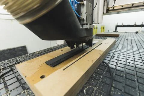 Closeup shot of the milling machine machine cutting the fiber, guitar factory Stock Photos