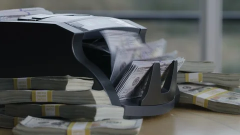 Closeup shot of money counting machine with 100 dollar bills. Stock Footage