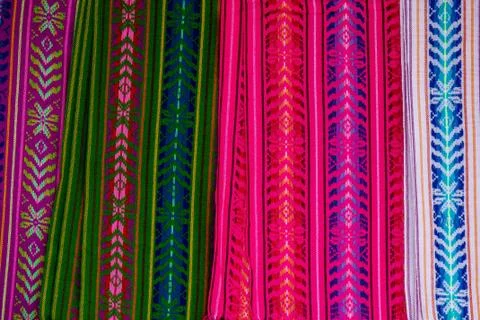 A closeup shot of multicolored and patterned pieces of clothing put next to e 스톡 사진