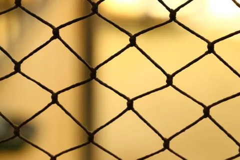 Closeup shot of a net behind a light background Stock Photos