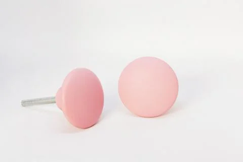 Closeup shot of pair of pink knobs isolated on a white background Fotos de archivo