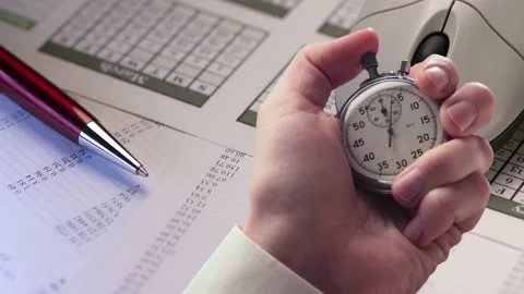 A closeup shot of a paperwork concept and stopwatch in a hand Stock Footage 235154732