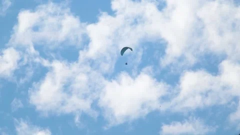 Closeup shot of parachute in front of clouds on blue sky.  Stock Footage 187398440