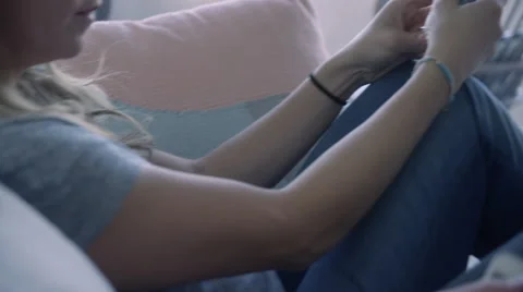 Closeup shot of parents couch surfing on the smart phones, in morning light. Stock Footage 65327232