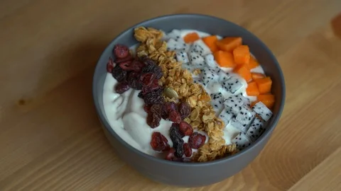 Closeup shot of a process of making a smoothie bowl with papaya, dragon fruit Stock Footage 107752031
